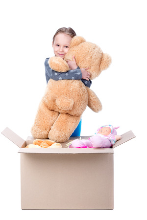 Little girl playing with soft toys. Isolated on white の写真素材