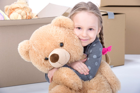 Little girl playing with soft toys. Isolated on white の写真素材