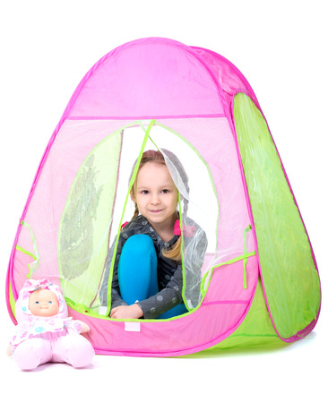 Little girl playing toy tent. Isolated on white の写真素材