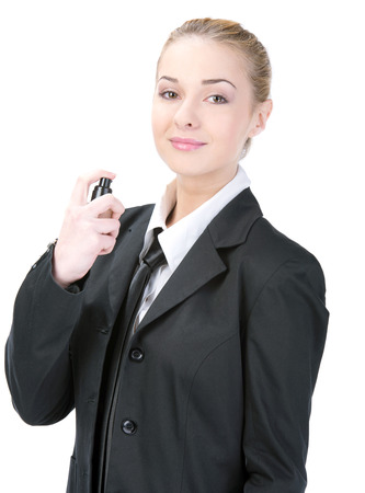 Woman with perfume, young beautiful girl holding bottle of perfume and smelling aroma, isolated on whiteの写真素材