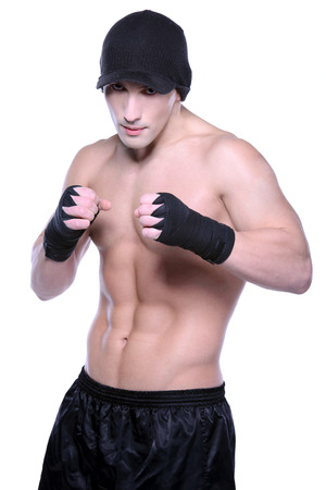 Muscled male model posing on isolated whiteの写真素材