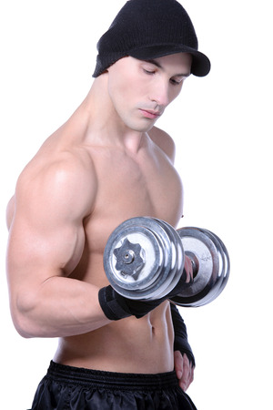 Muscular guy doing exercises with dumbbells over white backgroundの写真素材