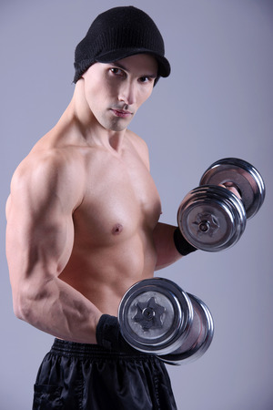 Closeup of a muscular young man lifting weightsの写真素材