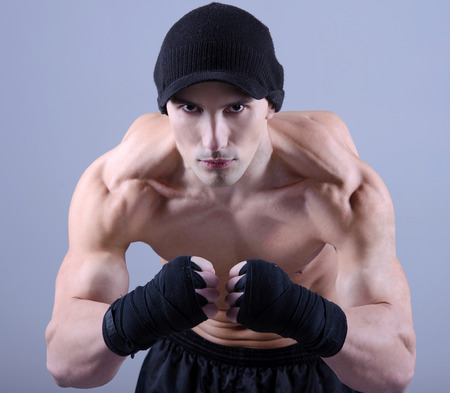Muscular man flexing his biceps - studio shotの写真素材
