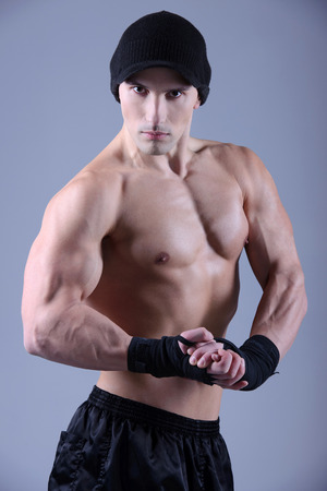 Muscular man flexing his biceps - studio shotの写真素材