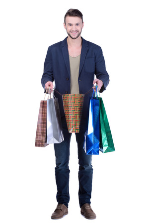 Young handsome man in suit with shopping bags. isolated on white backgroundの写真素材