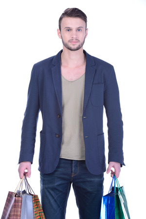 Young handsome man in suit with shopping bags. isolated on white backgroundの写真素材