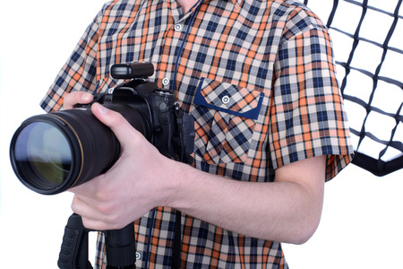 Portrait of young male photographer with professional digital cameraの写真素材