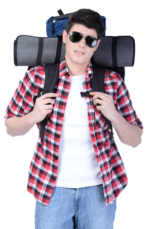 Young man with backpack walking isolated on white backgroundの写真素材