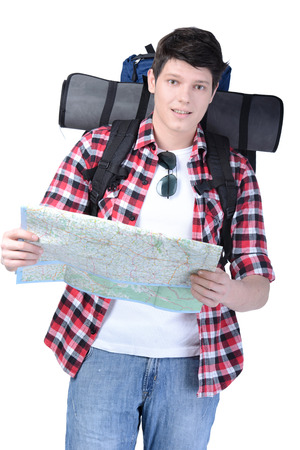 Young man with backpack and a map isolated on white backgroundの写真素材