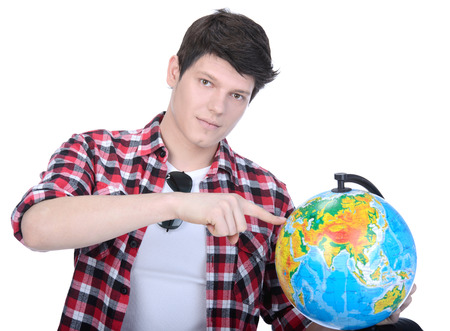 Portrait of a young man holding a globe for travel, isolated on white backgroundの写真素材