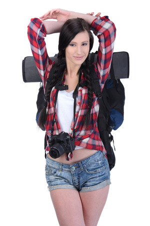 Smiling traveling girl with a camera Isolated on white backgroundの写真素材