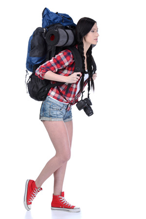 Smiling traveling girl holding a camera and looking at you, closeup portrait. Isolated on white backgroundの写真素材