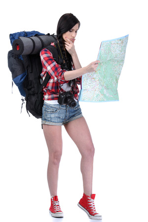 Smiling traveling girl holding a map Isolated on white backgroundの写真素材