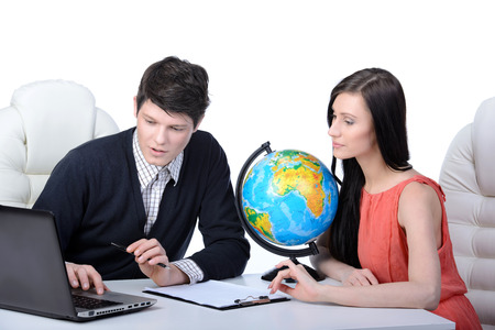 Travel agency. Man and woman at office decide to travel. studio shootingの写真素材