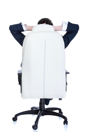 Confident handsome businessman sitting on chair, smiling. Isolated on white backgroundの写真素材