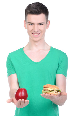Young man eating fast food isolated on white backgroundの写真素材