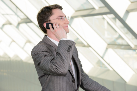 Portrait of a smiling handsome businessman in a business centerの写真素材