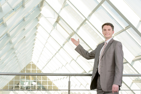Portrait of a smiling handsome businessman in a business centerの写真素材