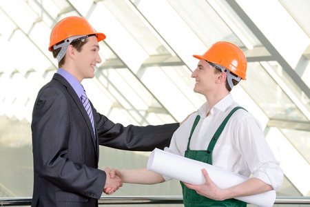 Two men in hard hats at construction siteの写真素材