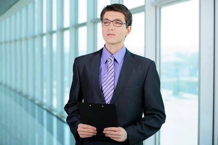 Portrait of a smiling handsome businessman in a business centerの写真素材