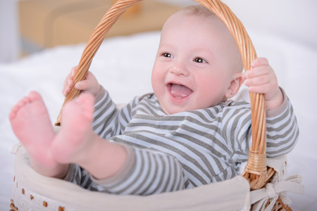 Portrait of a little baby in a basket. Happiness familyの写真素材