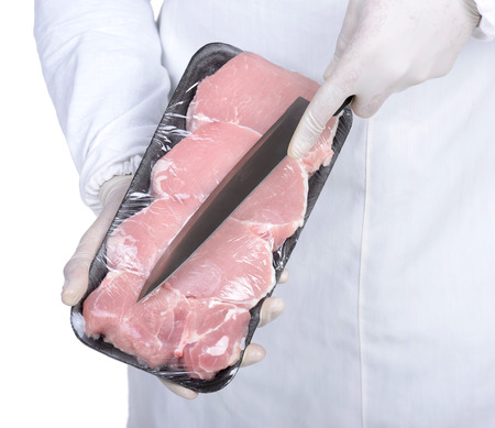 Professional butcher holding red meat. chef showing food on plate and smilingの写真素材