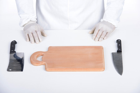 Man wearing apron holding knife. handsome butcher smiling and holding knifeの写真素材