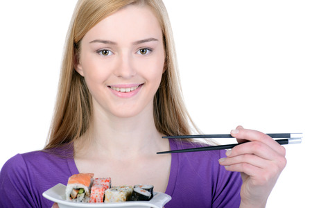 Beauty with sushi. Beautiful woman holding a plate of sushi while standing isolated on whiteの写真素材