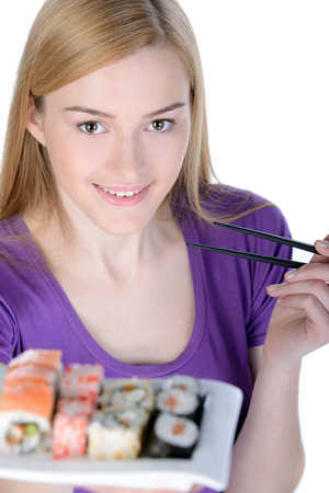 Beauty with sushi. Beautiful woman holding a plate of sushi while standing isolated on whiteの写真素材