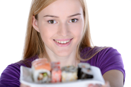 Beauty with sushi. Beautiful woman holding a plate of sushi while standing isolated on whiteの写真素材