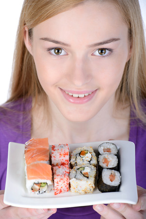 Beauty with sushi. Beautiful woman holding a plate of sushi while standing isolated on whiteの写真素材