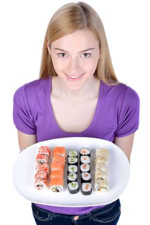 Beauty with sushi. Beautiful woman holding a plate of sushi while standing isolated on whiteの写真素材