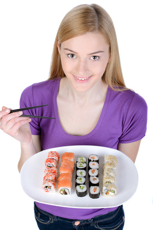 Beauty with sushi. Beautiful woman holding a plate of sushi while standing isolated on whiteの写真素材