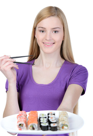 Beauty with sushi. Beautiful woman holding a plate of sushi while standing isolated on whiteの写真素材