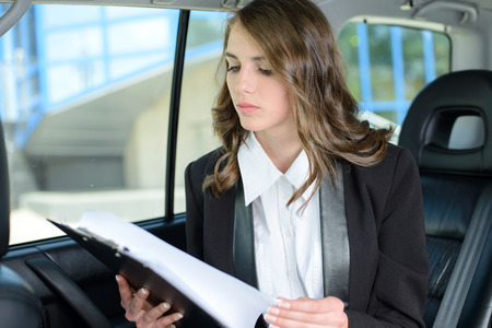 The young successful business woman traveling in the carの写真素材