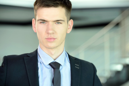 Portrait of a smiling handsome businessman in a business centerの写真素材
