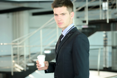 Portrait of a smiling handsome businessman in a business centerの写真素材