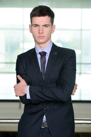 Portrait of a smiling handsome businessman in a business centerの写真素材