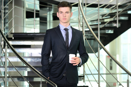 Portrait of a smiling handsome businessman in a business centerの写真素材