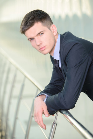 Portrait of a smiling handsome businessman in a business centerの写真素材