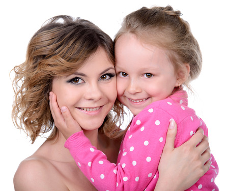 Portrait of happy daughter and her mother, isolated over whiteの写真素材