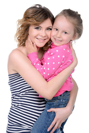 Portrait of happy daughter and her mother, isolated over whiteの写真素材