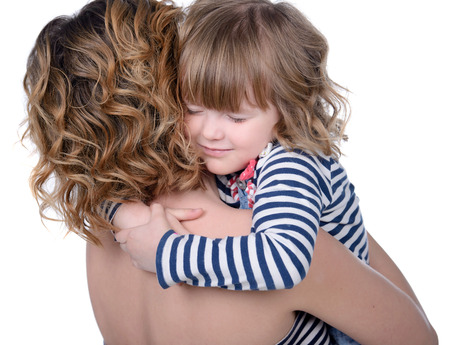 Portrait of happy daughter and her mother, isolated over whiteの写真素材