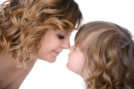 Portrait of happy daughter and her mother, isolated over whiteの写真素材