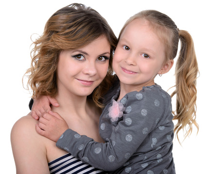 Portrait of happy daughter and her mother, isolated over whiteの写真素材