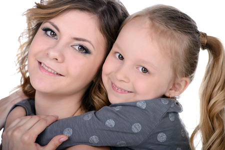 Portrait of happy daughter and her mother, isolated over whiteの写真素材
