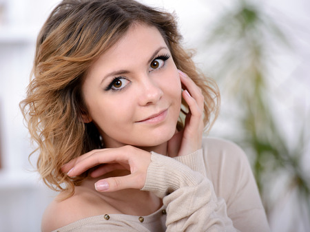 Attractive blond woman relaxing in sofa at homeの写真素材