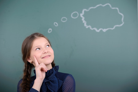 Portrait of child school education against the background of blackboard