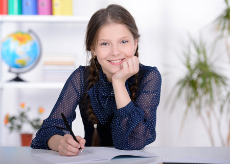 Portrait of a school child, making learning during lesson at schoolの写真素材